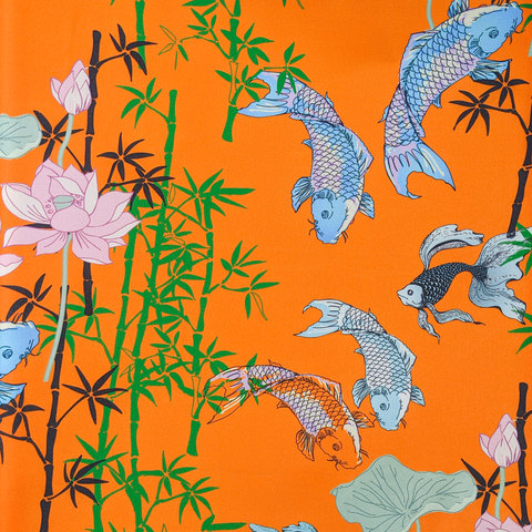 Orange polyester silk fabric with an illustration of Koi fish swimming around bamboo and pink lotus flowers.
