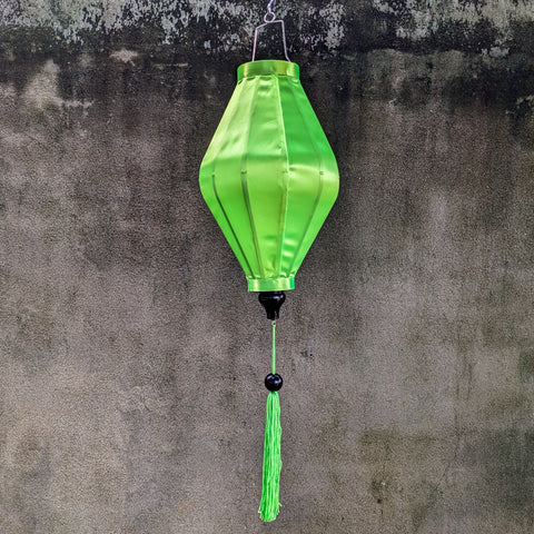 Lime green plain silk Vietnamese lantern handmade in Hoi An, Vietnam.