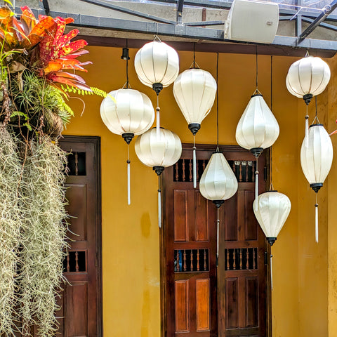 White lanterns with black trim hanging in Old Town, Hoi An.