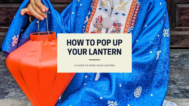 A Vietnamese woman dressed in traditional clothing sitting on the steps of a temple holding up a diamond shaped orange lantern with text box overlay: How to pop up your lantern, a guide to open your lantern.