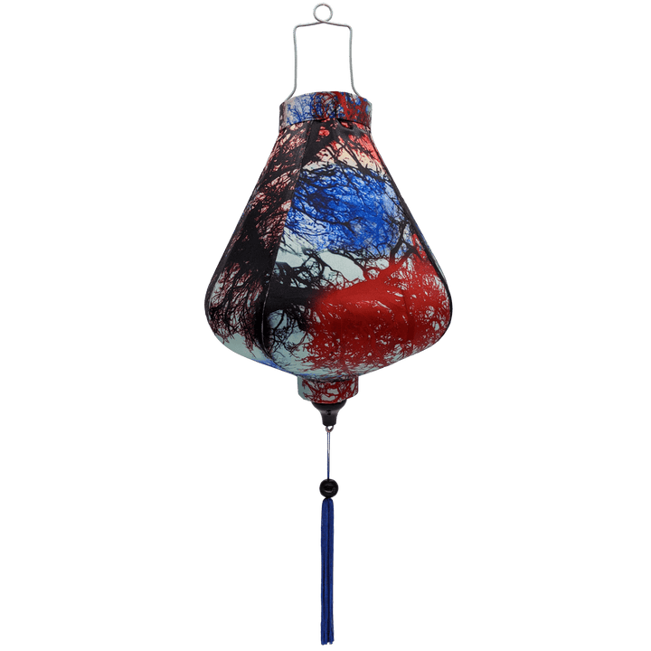 Teardrop shape Vietnamese lantern with silhouette of branches in hues of orange, red, and blue.
