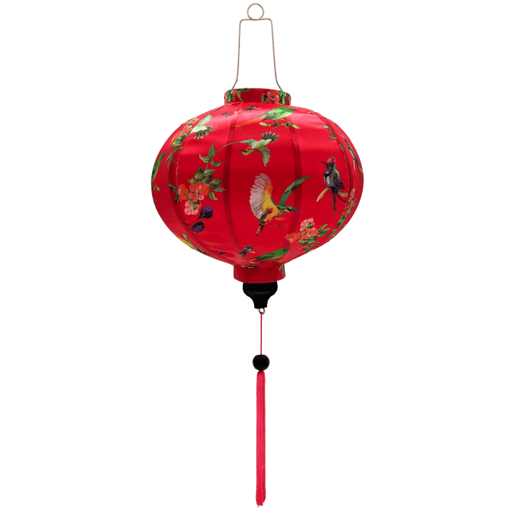 Round shaped lantern with pink tassel featuring a print of various birds in flight with peach flowers against a hot pink.
