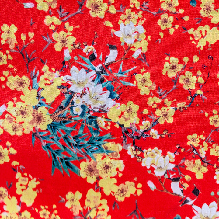 Polyester silk fabric with yellow and white flowers on a red background