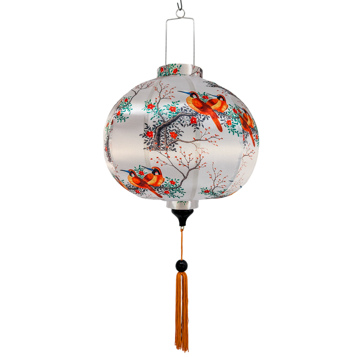 Round Vietnamese silk lantern handmade in Hoi An with bird and floral patterns on a white background.
