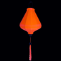 Glowing Orange UV lantern with matching tassel on a black background