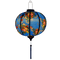 Glowing round lantern with wild flowers against blue.