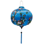 Round shape Vietnamese lantern with wild flowers in a rainbow of colours against a blue background.