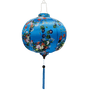 Round shape Vietnamese lantern with wild flowers in a rainbow of colours against a blue background.