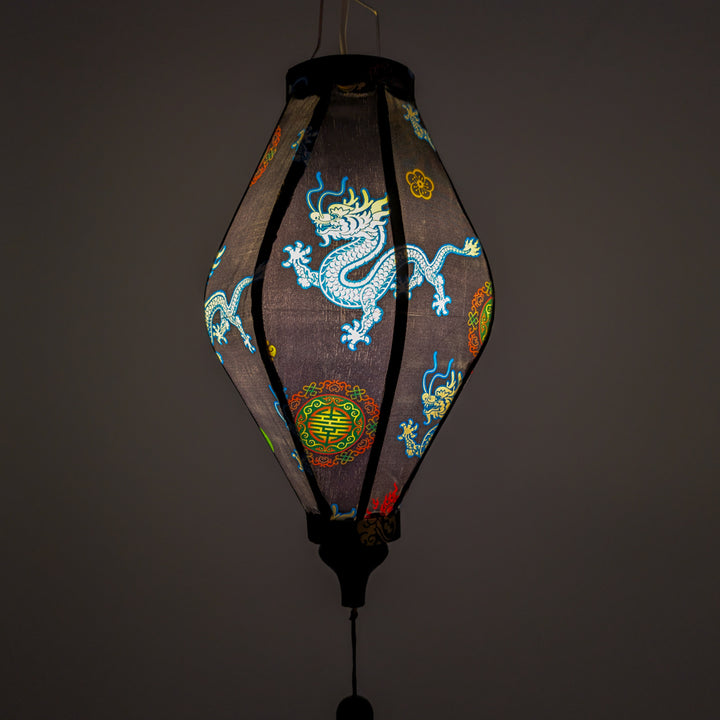 Glowing black silk lantern with blue dragons, symbols and red flames handmade in Hoi An.