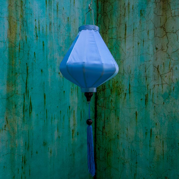 Plain light blue fabric with blue tassel.