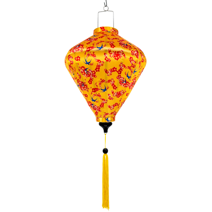 Handmade Vietnamese silk lantern with red floral pattern and blue swallows with yellow tassel on a yellow background