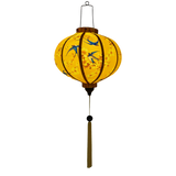 Glowing Traditional Vietnamese Round lantern with a smooth silk finish, ideal for indoor and outdoor decoration featuring blue swallows flying around with yellow flowers in their beaks on a yellow background.