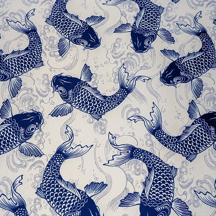 Polyester silk fabric with blue koi print, featuring a pattern of intricately detailed koi fish swimming amidst silver swirling water currents. 