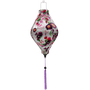 Tube Vietnamese silk lantern with botanical floral pattern with pinks and purples on white background. 