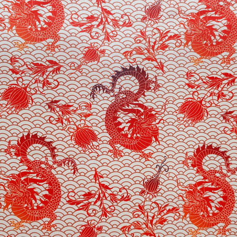 Polyester silk fabric featuring dip dyed burgundy red dragons and flowers on a silk beige background 