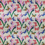 A close up of polyester silk fabric with a stunning print of blue, red and green butterflies fluttering around pink and purple flowers.