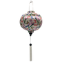 Round shaped lantern with white tassel made with bamboo, steel and a print of stunning print of blue, red and green butterflies fluttering around pink and purple flowers.