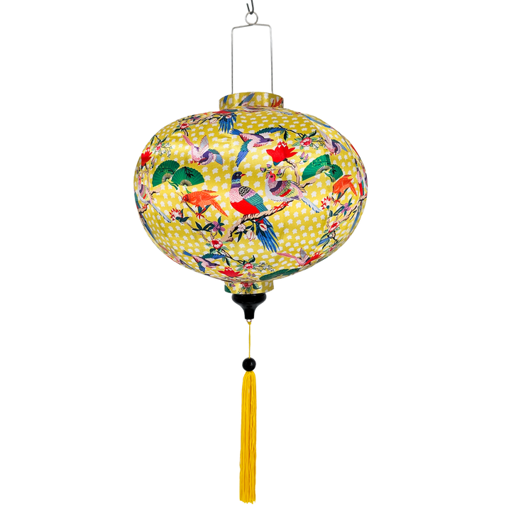 Hanging round Vietnamese silk lantern with bird pattern on a yellow background with yellow tassel
