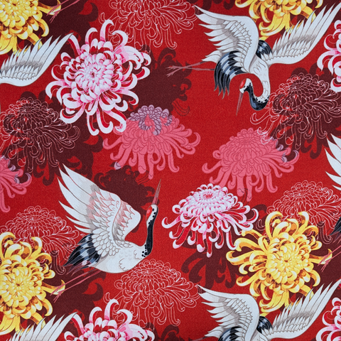 Traditional Japanese design with cranes and chrysanthemum flowers on a red background
