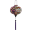 Round lantern with purple tassel.