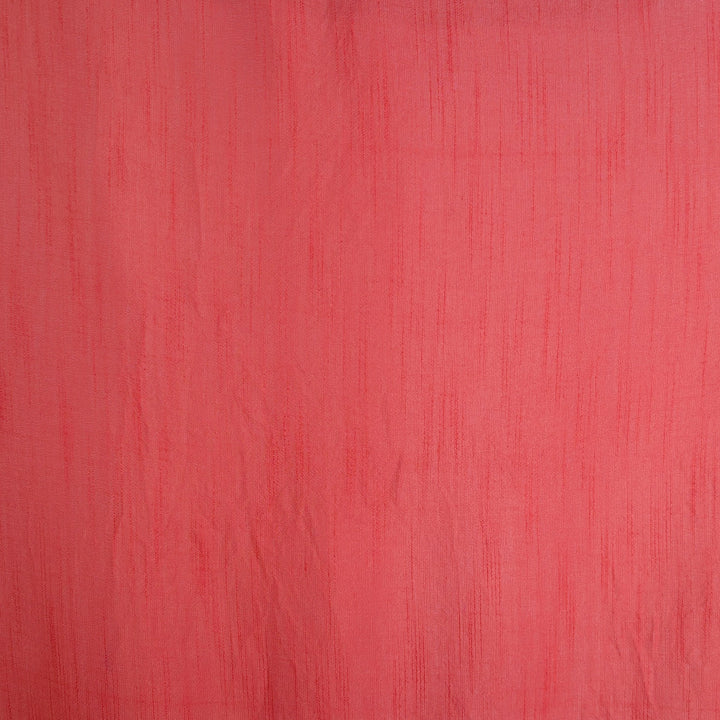 A close-up of a textured coral pink polyester linen fabric.