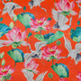 Polyester silk fabric with red-headed cranes and pink lotus flowers with large green leaves on bright orange silk used to created Vietnamese Lanterns in Hoi An.