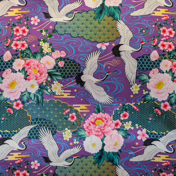 Decorative fabric pattern with cranes and flowers on a purple background