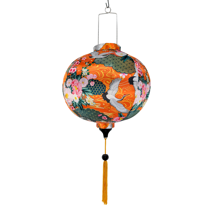 Round lantern with floral and crane design on an orange background with gold swirls.