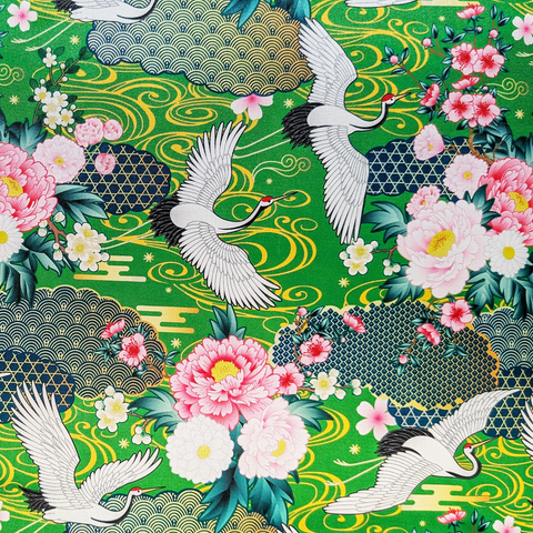 Traditional Japanese design with cranes and flowers on a green background