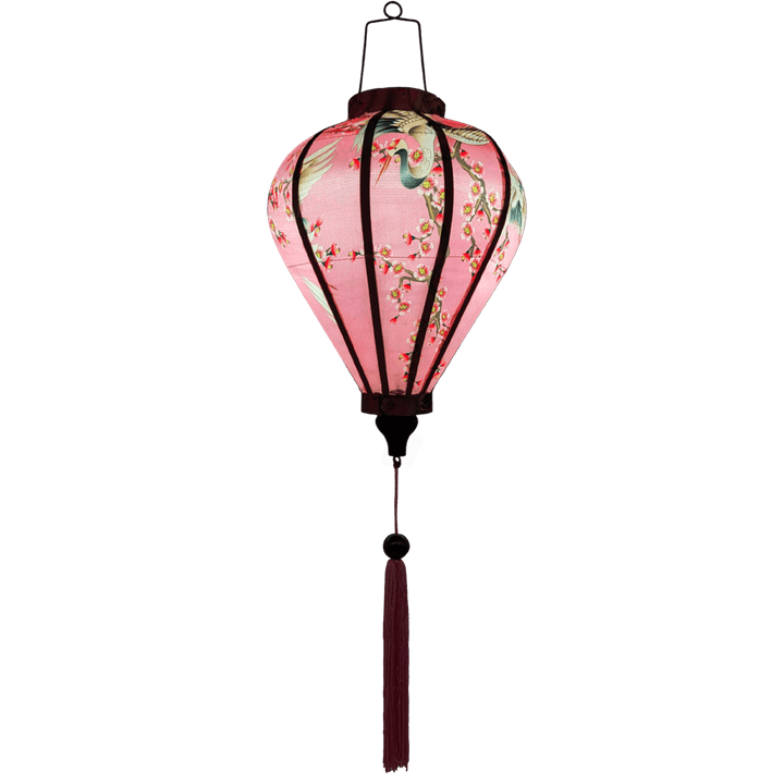 Glowing balloon shaped lantern with pink tassel.