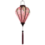 Glowing balloon shaped lantern with pink tassel.