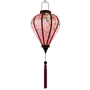 Glowing balloon shaped lantern with pink tassel.