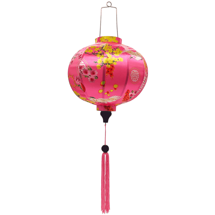 Round shaped Vietnamese lantern with pink tassels featuring a design of cranes, lanterns, firecrackers, and blooms of pink and yellow on a brilliant pink background. 