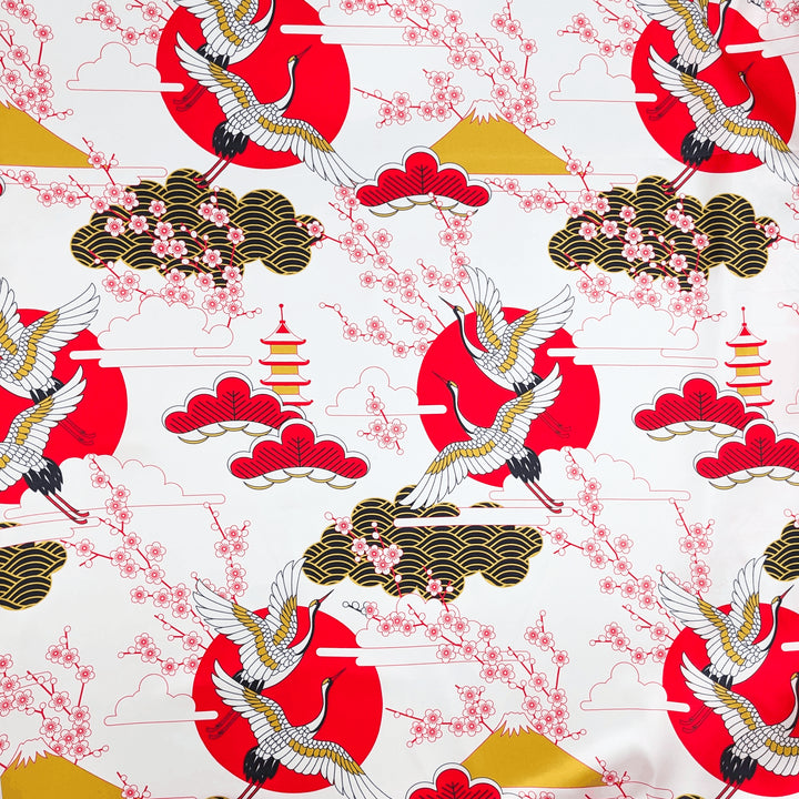 Polyester silk fabric featuring white cranes with golden wings soaring through a landscape of golden clouds, volcanos, and red blossoms on white background.