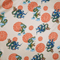 Polyester silk fabric with green and blue dragons on a rich creamy backdrop.