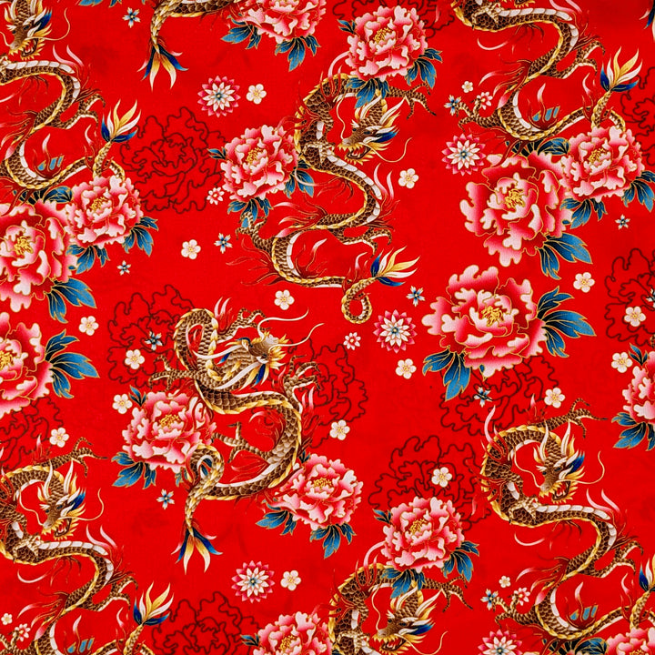 Polyester silk fabric with golden dragons and large pink chrysanthemums with teal leaves used for creating Vietnamese hand made lanterns in Hoi An.