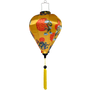 Decorative lantern with yellow background, red patterns, and tassel.