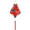 Teardrop shaped Vietnamese lantern with red tassel and design of yellow fans, a house overlooking trees beneath snow capped mountains and surrounded by blooms of pink on a brilliant red background. 