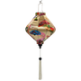 Lozenge shaped lantern with white tassel featuring a print with quirky fans shaped in diverse styles and colours, seamlessly set against a captivating cream backdrop. 
