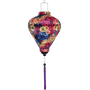 Balloon shaped lantern with fireworks display print and purple tassel.