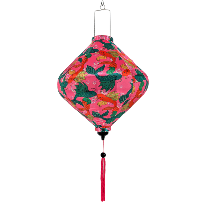 Lozenge shaped Vietnamese silk lantern with pink background and green and orange fish design on a bright pink background and matching pink tassel.