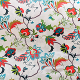 Up close polyester silk fabric with a beautiful illustration of flowers in blue, green and orange colours against cream background.