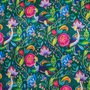 Close up of polyester silk fabric featuring a print of lush, tropical flowers and birds on a deep green silk fabric. 