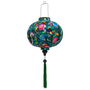 Round shaped lantern with green tassel featuring a print of lush, tropical-inspired design with birds and flowers on a deep green silk fabric.