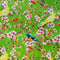 A vibrant fabric design featuring a lush green background with delicate cherry blossoms in full bloom. The branches are adorned with clusters of pink and white flowers, along with small red and orange cherries. Among the blossoms, bright yellow canaries and striking blue and orange flycatchers are perched.