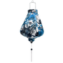 Teardrop shape Vietnamese lantern with white tassel and silk fabric with a print of geometric shaped flowers in muted blue colours.