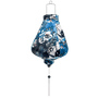 Teardrop shape Vietnamese lantern with white tassel and silk fabric with a print of geometric shaped flowers in muted blue colours.