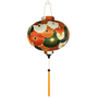 Round shaped lantern with flowers with gold outline in colours orange, white, green, and dark blue.
