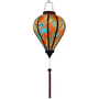 Glowing Balloon shaped Vietnamese lantern with red, blue, orange, green and yellow paisley print.
