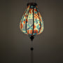 Glowing silk lantern with geometric pattern on a white background with white matching tassel.